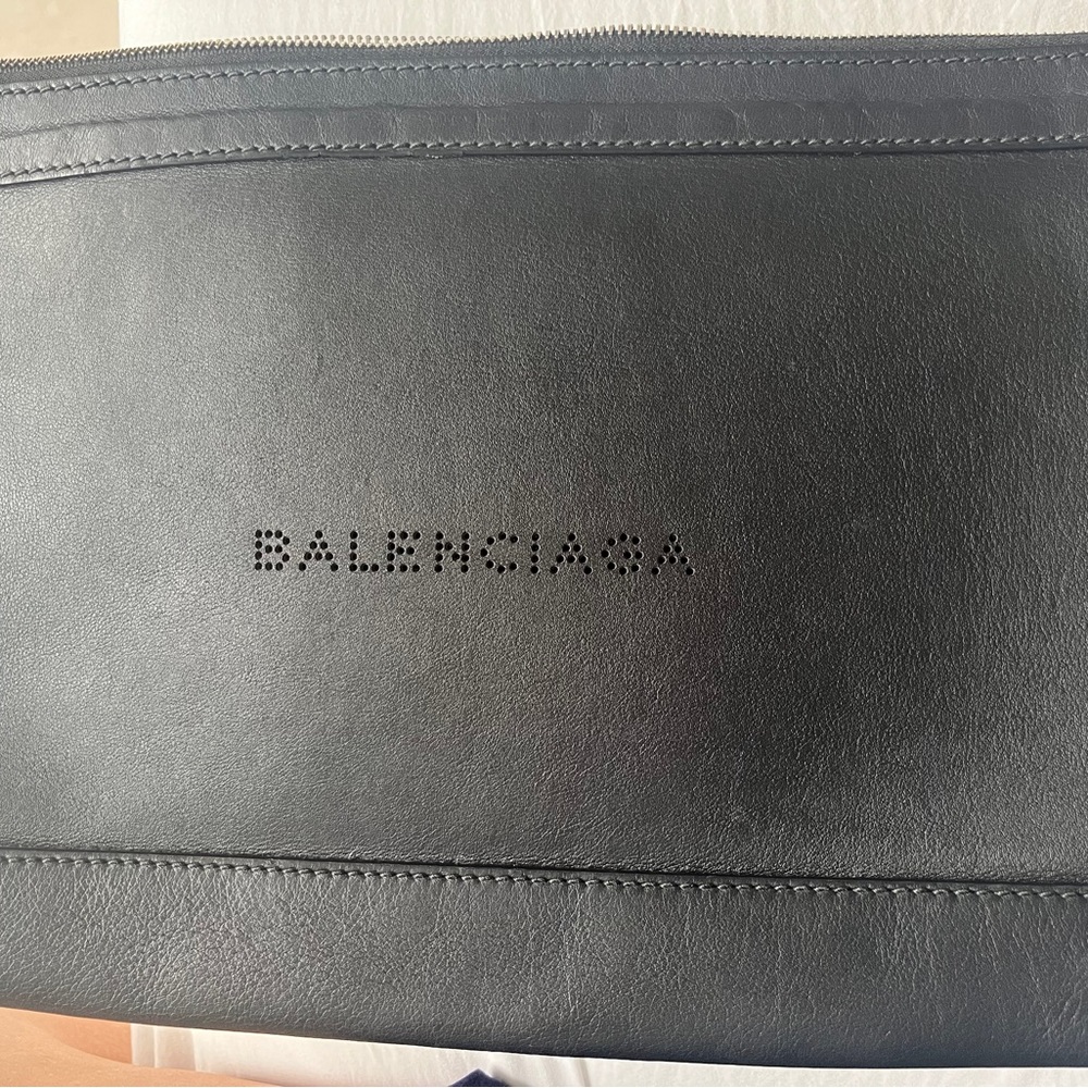 Balenciaga black leather clutch bag.